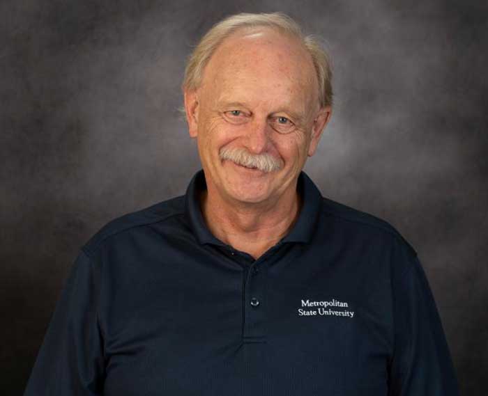 Individual in navy blue polo shirt