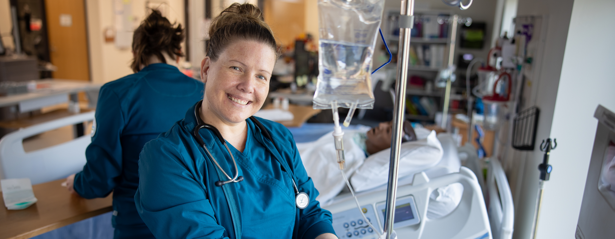smiling student in blue nursing scrubs